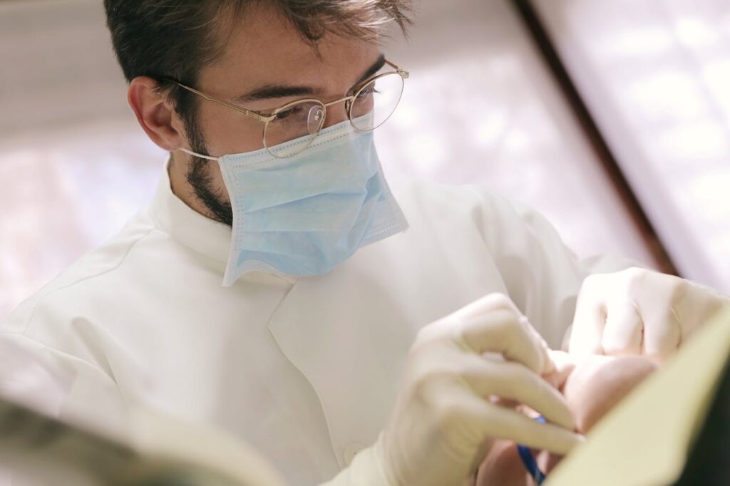 Dentist performing wisdom teeth removal procedure safely