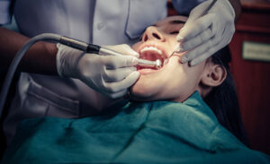 A patient having a tooth extracted by a dentist.