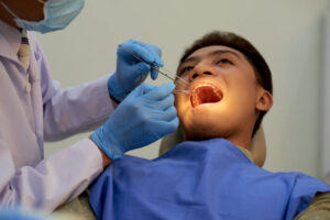 A patient undergoing tooth removal performed by a dentist.