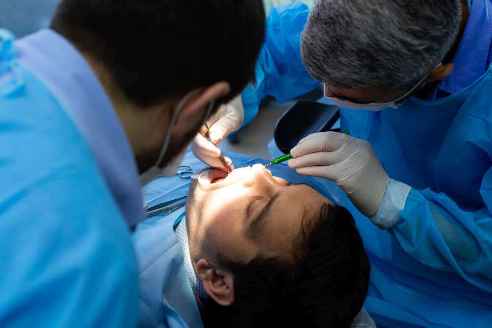 A patient undergoing tooth removal performed by a dentist.