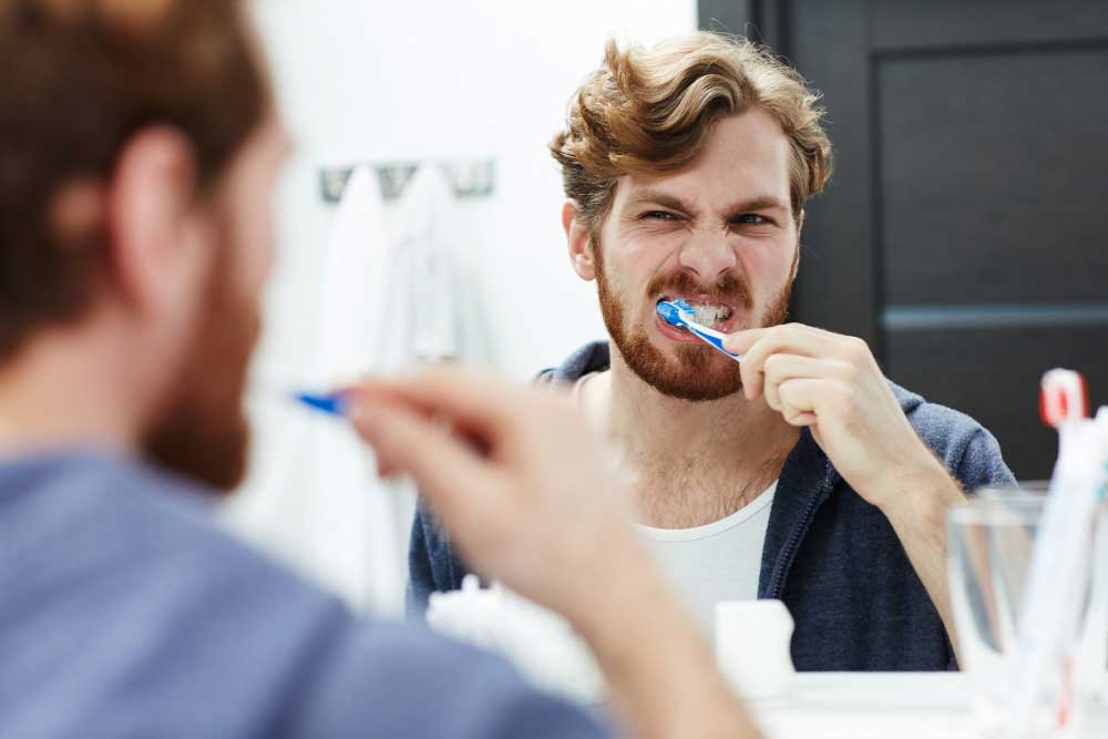 Brushing teeth gently after wisdom teeth removal to support healing and prevent infection