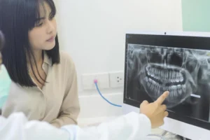 Dentist reviewing wisdom teeth x ray with patient in Sydney