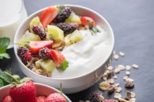 Healthy yogurt granola bowl with fruits for recovery after wisdom teeth removal